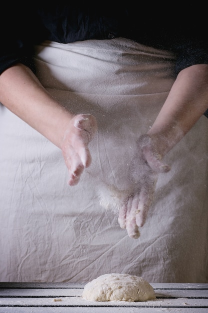 Close-up of someone kneading dough rhythmically, showcasing the smooth texture and repetitive motion that many find satisfying.