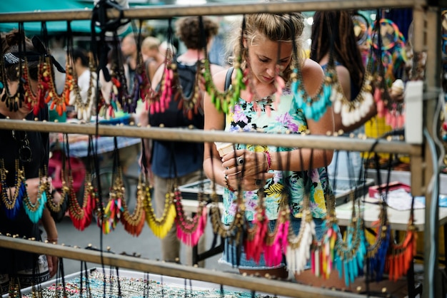 A vibrant marketplace scene showcasing vendors selling a variety of upcycled products: jewelry made from recycled metal, bags made from repurposed fabric, and artwork made from salvaged materials. The scene is lively and bustling, reflecting the growing demand for upcycled goods.