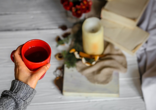 A person journaling in a cozy setting, with a cup of tea and soft lighting, showing a sense of peace and reflection.