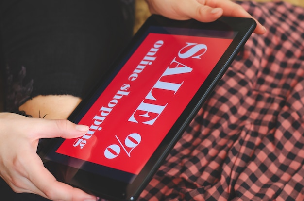 A close-up view of a smartphone screen displaying a coupon code for a popular product, with a hand hovering over the 