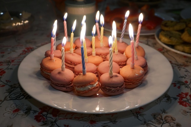 A birthday cake adorned with sparkling candles, with several discount coupons placed artfully around it. The coupons are from various retailers, suggesting a wide range of birthday offers.