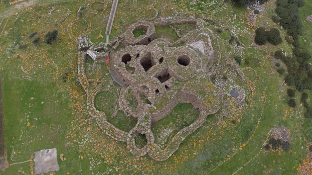An aerial view of the Georgia Guidestones showing the arrangement of the stones in relation to the surrounding landscape. The photo captures the monument's isolated setting and the patterns formed by the granite slabs.