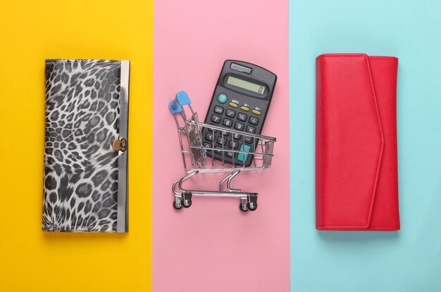 A close-up shot of various coupons neatly organized in a coupon binder, with scissors and a calculator beside it.