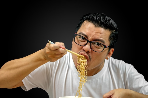 A person struggling to consume a large quantity of spicy noodles, with visible signs of discomfort like sweating and flushed cheeks, highlighting the immediate physical distress caused by such challenges.