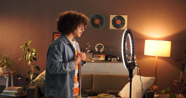 A content creator filming an ASMR video in a cozy studio, using professional microphones and lighting equipment.